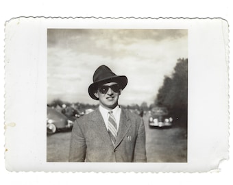 Fedy at the polo game. Vintage snapshot of a stylish young man wearing large sunglasses.