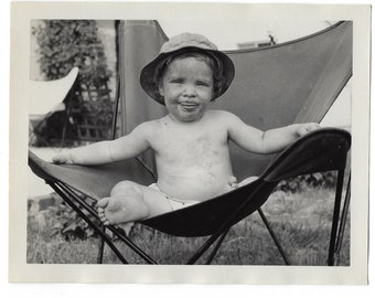 What a dirty face! Undated original photo of a baby in a butterfly chair.