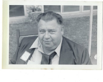 1970s vintage close-up snapshot of a large man (Walt Solarz) with his tie undone.