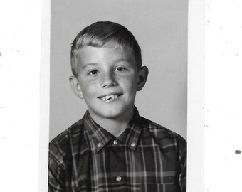 Freckles. Undated vintage school days photo of a boy with chipped teeth.