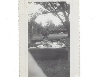 Cooling off. Undated vintage photo of a boy playing in a kiddie pool.