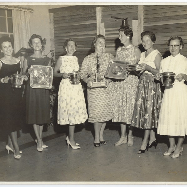 Golf Champions: Larger photo of fashionable 1960s women holding various awards.
