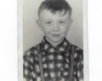 Cute kid. Undated school photo of a boy wearing a plaid shirt and suspenders.