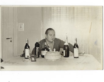 Happy Birthday? Undated photo of an angry 49-year-old man surrounded by cake and wine.