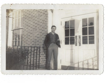 Big man on campus. 1940s vintage photo of a handsome young man with a pocket watch.