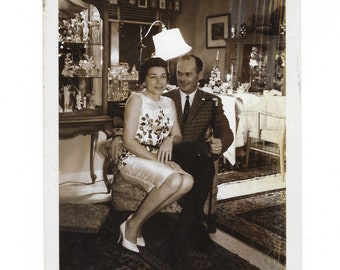 Christmas portrait. 1962 vintage photo of an elegant couple in their well-appointed home.