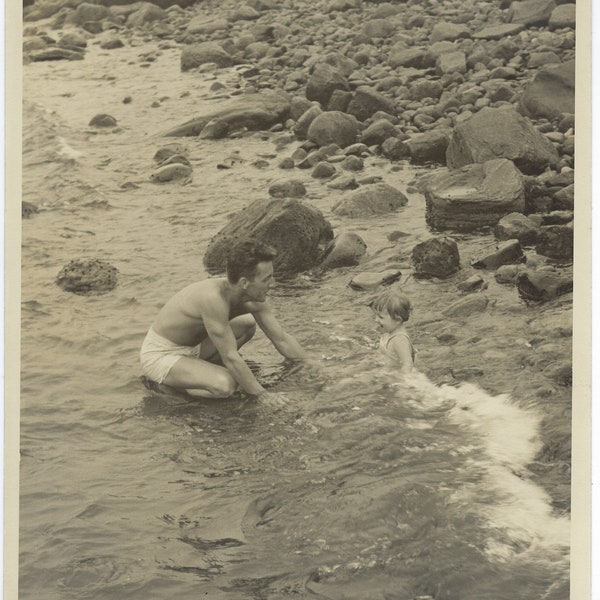 Daddy-Daughter Quality Time. Larger 8" x 10" photo of a man and toddler playing on a rocky beach.