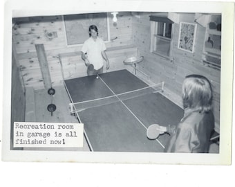 Ping Pong! 1970s vintage snapshot photo of 2 teens playing in a rec room.