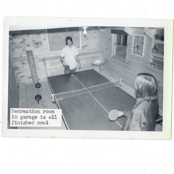 Ping Pong! 1970s vintage snapshot photo of 2 teens playing in a rec room.