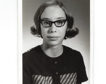 Future fashion icon. Small vintage school photo of a girl with an excess of style.