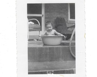 Bath time! Undated vintage snapshot of a baby in a tub on a porch.