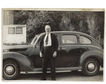 Pops posed with his 1938 Ford. Vintage snapshot photo of a middle-aged man standing next to his car.