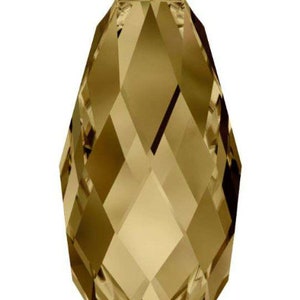 May include: A faceted teardrop-shaped crystal bead in a golden brown color.
