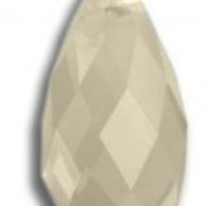 May include: A clear glass teardrop-shaped crystal bead with a faceted design.