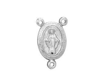 May include: Silver oval-shaped pendant featuring a depiction of the Virgin Mary with the text "Our Lady of Guadalupe" surrounding the image.