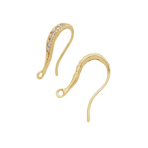 May include: A pair of gold-tone earring hooks with clear crystal accents.