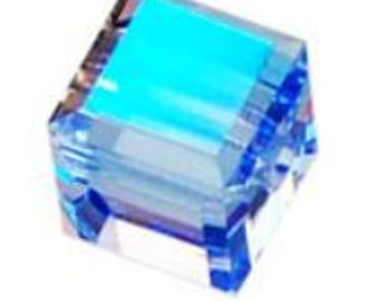 May include: A single, square, light blue crystal bead with a clear center.