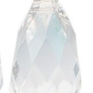 May include: A clear crystal teardrop pendant with a faceted design. The pendant is made of glass and has a shiny finish.
