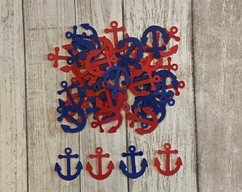 May include: A pile of red and blue paper anchor cutouts on a wood background. There are five anchors in a row at the bottom of the image.