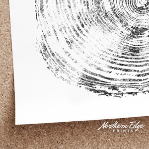 May include: Black and white print featuring a detailed, circular pattern resembling tree rings. The print is on white paper, with the corner of the paper visible. The words "Northern Edge Prints" are in the bottom right corner.