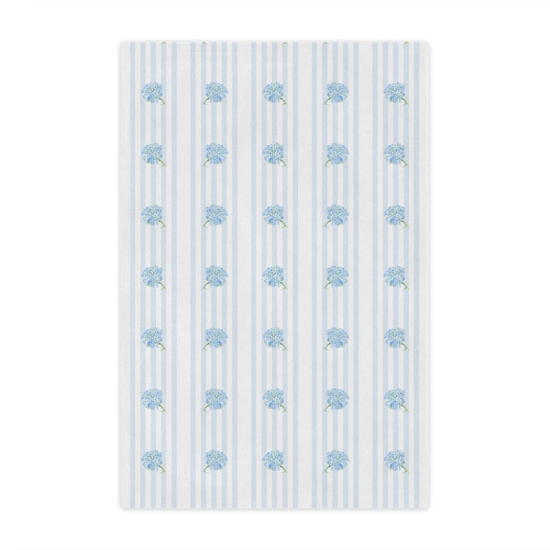 May include: A white background with blue stripes and a repeating pattern of blue hydrangea flowers.