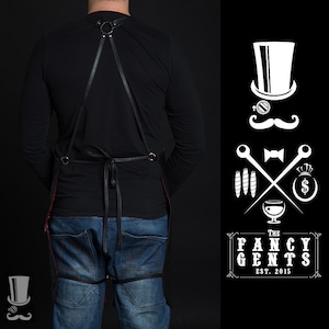 May include: A black leather apron with adjustable straps and a red lining. The apron is worn by a person with a black shirt and blue jeans. The image also includes a logo with the text "The Fancy Gents Est. 2015" and a stylized illustration of a gentleman with a top hat, monocle, mustache, bow tie, and crossed cigars.