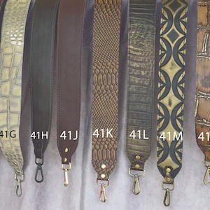 May include: A collection of 15 different leather straps with various patterns and colors, including black, brown, beige, white, and green. Each strap has a metal clasp at one end. The straps are labeled with numbers from 41A to 41S.