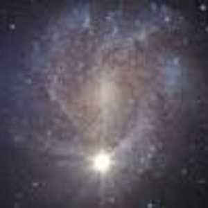 May include: A digital art image of a nebula in space. The nebula is a swirling mass of colors, including blues, golds, and whites, with a bright star at its center. The background is a dark, star-filled sky.