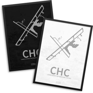 May include: Two framed prints featuring airport diagrams. One print has a black background with a gray airport layout, the letters "CHC", and the text "Christchurch International Airport". The other print has a white background with a gray airport layout, the letters "CHC", and the same text.