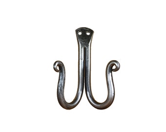 May include: A double-ended, silver-colored metal hook with a decorative swirl at the end of each hook. The hook has a flat, rectangular base with two holes.