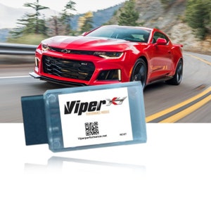 Puede incluir: Un módulo de rendimiento Viper azul y gris con un código QR y el texto "Viper Performance Module" y "Viperperformance.net". El módulo tiene un botón etiquetado como "Reset".