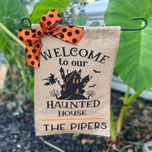 Welcome to our haunted house personalized garden flag