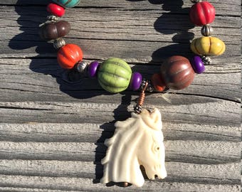 Carved bone horse & stone bead bracelet. Multi colored howlite and silver bead elastic bracelet. Fits any hand.