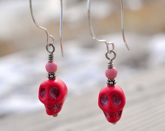 Silver wire earrings with hot pink howlite skull.