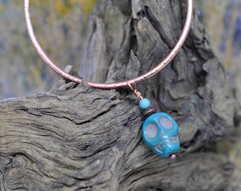 Copper bangle bracelet with Turquoise Howlite skull bead. These are great for layering with other bangle bracelets