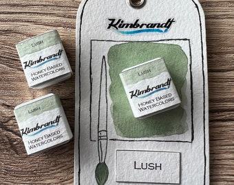 May include: Three watercolor paint pans labeled "LUSH" with the brand name "Kimbrandt" and the text "HONEY BASED WATERCOLORS".