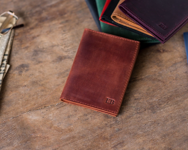 May include: A brown leather wallet with the initials "EB" embossed on the front.
