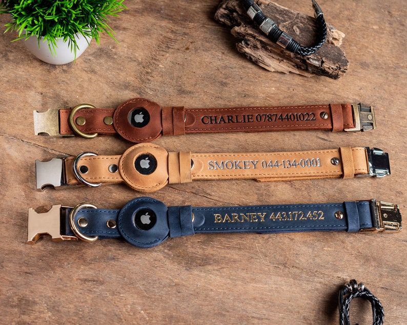 May include: Three leather dog collars in brown, tan, and navy blue, each with a metal buckle and a holder for an Apple AirTag. The brown collar is engraved with "CHARLIE 07874401022". The tan collar says "SMOKEY 044-134-0001". The navy collar says "BARNEY 443.172.452".