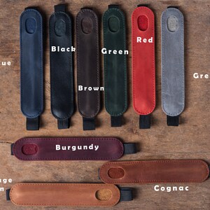 May include: Assortment of leather pen sleeves in various colors, including blue, black, brown, green, red, grey, burgundy, vintage brown, and cognac.