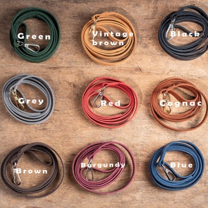May include: Nine leather cords in different colours, including green, vintage brown, black, grey, red, cognac, brown, burgundy, and blue. Each cord has a metal clasp.