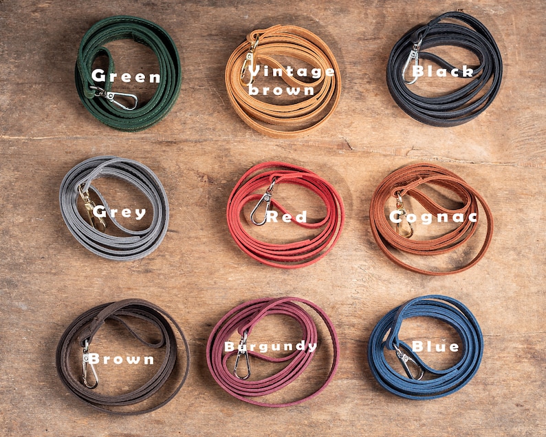 May include: Nine leather cords in different colours, including green, vintage brown, black, grey, red, cognac, brown, burgundy, and blue. Each cord has a metal clasp.