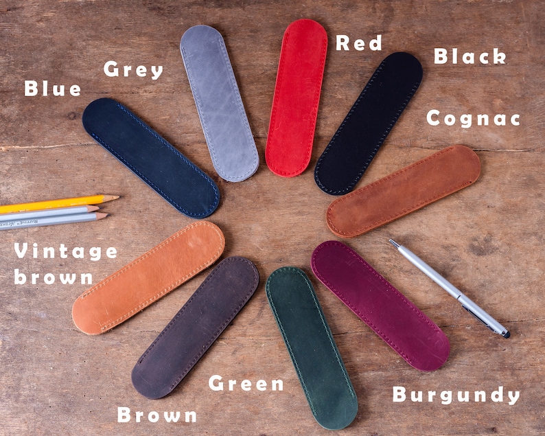 May include: Assortment of 10 leather pencil cases in various colours, including blue, grey, red, black, cognac, vintage brown, brown, green, burgundy.