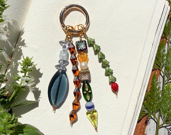 Whimsical Bag Charm with 4 Strands of Vintage Czech Glass Motifs: Large Teal Oval, Glass, Ladybug, Leaf + Pearl + Rough Aquamarine