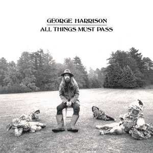 May include: A black and white album cover featuring George Harrison sitting on a stool in a field, surrounded by four garden gnomes. The text GEORGE HARRISON and ALL THINGS MUST PASS is printed in black at the top of the image.