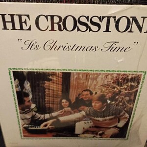 May include: A vintage vinyl record album cover featuring a band called "The Crosstones" with the title "It's Christmas Time". The cover art shows a group of people playing music in a cozy setting.