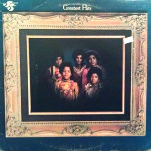 May include: A vintage vinyl record album cover featuring a group of five young men, all wearing casual clothing. The album cover is titled "Greatest Hits" and features a picture of the group in a framed portrait. The background is a dark green color.