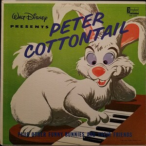 May include: A vintage Walt Disney record album cover featuring Peter Cottontail, a white rabbit with a red nose and blue eyes, playing a piano. The album title is in blue, with a green background. The text reads "Plus Other Funny Bunnies and Their Friends."