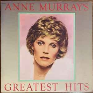Può includere: Una copertina di un album in vinile con un ritratto di Anne Murray, una donna bionda su uno sfondo rosa chiaro. Il titolo dell'album è "Anne Murray's Greatest Hits".