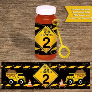 May include: A yellow and black construction themed birthday party favour bubble bottle label with a yellow construction truck and the text "HUNTER'S 2".