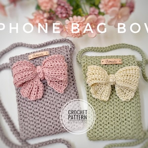 May include: Two crocheted phone bags with bows. The bag on the left is a light purple color with a pink bow. The bag on the right is a light green color with a cream colored bow. Both bags have a leather tag that says "Vivmade". The text "CROCHET PATTERN BY VIVMADE" is printed below the bags.
